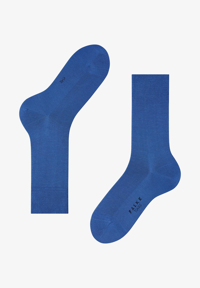 Chaussettes bleues en matériau tricoté lisse avec un bord côtelé. Présentent un design de orteil sans couture et une lettrage de marque sur la semelle.