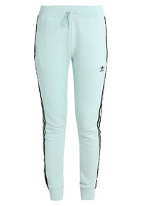 Mátově zelené tepláky s černými postranními pruhy, elastickým pasem a šňůrkou na stažení. Na levém boku je logo Adidas. Měkká textilie.