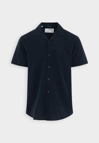 Hedvábná krátký rukáv košile v tmavě námořní modři, s límečkem, zapínáním na knoflíky a rovnými lemy s zaoblenými okraji. Lehká a prodyšná tkanina.
