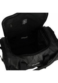 Borsone nero realizzato in materiale resistente; presenta una tasca con zip, ampia apertura, doppi manici e dettaglio del logo all'interno.