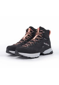 Black waterproof hiking boots with a textured finish, orange accents, and durable rubber soles. Features reflective laces and a high ankle design.
