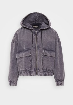 Sivi korduroj jakna s kapuljačom, zatvaranje na zip, dva prednja džepa, elastične manžete i rub. Ima teksturiranu površinu s opuštenim krojem.