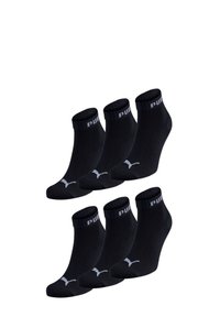 Black ankle socks made of cotton blend, featuring ribbed cuffs, a logo on the band, and a low-cut design. Pack of six pairs.