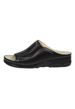 Black open-toe slip-on leather sandal with beige cushioned insole, white stitching, and textured black rubber sole.