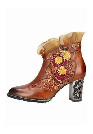 Stivaletto alla caviglia in pelle marrone con ricamo floreale, borchie decorative, bordo in tessuto arricciato e tacco largo nero decorato con motivi.