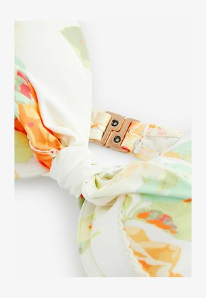 Bikini gornji dio s cvjetnim uzorkom u pastelnim bojama, s detaljem čvora i metalnom kopčom sa dva crna zakovica. Glatka tekstura tkanine.