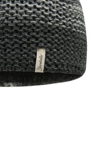 Dark gray knitted wool beanie with a textured pattern and a small fabric tag sewn on the edge.