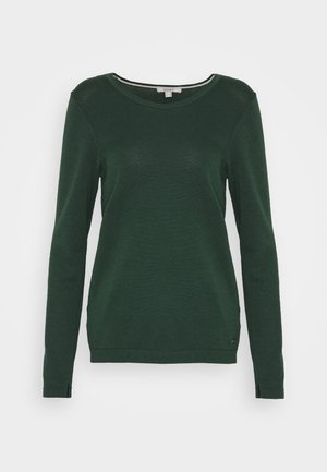 Dark green long-sleeve sweater in a ribbed texture with a round neckline and side slits. Features a small tag at the hem.