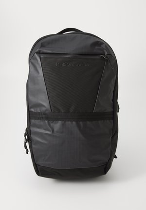 Black backpack with a textured body, smooth panels, and a subtle grid pattern. Features a logo, a zippered pocket, and a top handle.