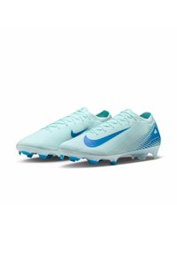 Light blue soccer cleats with a textured finish, featuring a dark blue Nike Swoosh and a patterned design along the sides.
