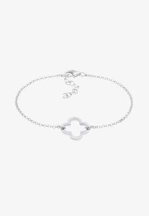 Bracelet délicat en chaîne argentée avec un charme ouvert en forme de quadrilobe et un fermoir mousqueton avec chaîne d'extension réglable.