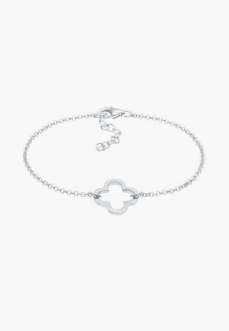 Bracelet délicat en chaîne argentée avec un charme ouvert en forme de quadrilobe et un fermoir mousqueton avec chaîne d'extension réglable.