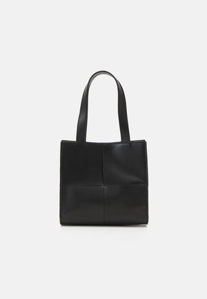Black leather tote bag with two handles, rectangular shape, smooth texture, and stitched panel design. No hardware or additional accents.