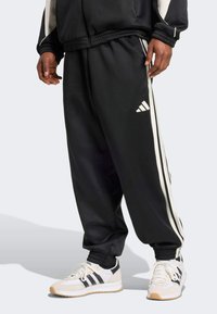 adidas Sportswear - Træningsbukser - black/off-white Miniaturebillede 1