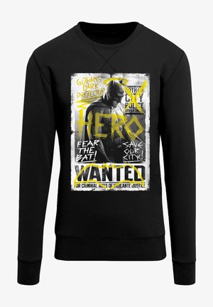 Czarna bluza z grafiką przedstawiającą mściciela inspirowanego nietoperzami. Druk zawiera żółty tekst oraz zniszczoną, plakatową teksturę.