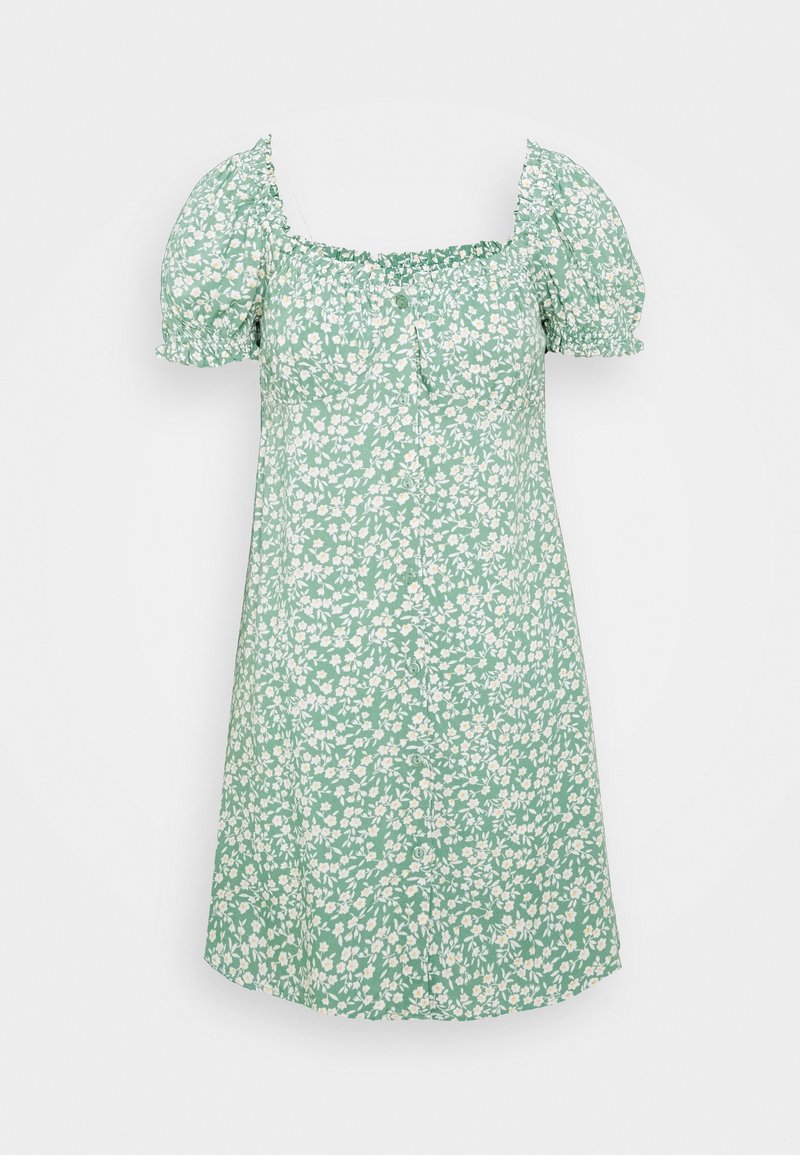 Robe courte verte à motif floral blanc, manches courtes bouffantes, encolure carrée, et boutons sur le devant.