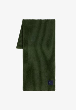 Vihreä ribbikuvioinen neulehuivi, jossa on suorakaiteen muoto, ja jossa on tummansininen logo-patch. Kestävä kangas, jossa on teksturoitu ulkonäkö.