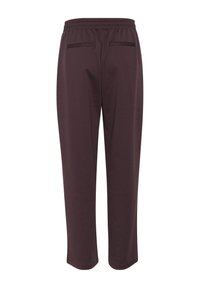 Pantaloni jogger bordeaux con vita elasticizzata, gambe affusolate e due tasche posteriori. Realizzati in tessuto liscio ed elasticizzato per il massimo comfort.