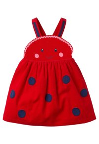 Robe rouge pour tout-petit avec bretelles, décorée d'un visage souriant sur le buste et de pois bleu marine sur la jupe.