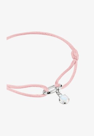 Delicate pink cord bracelet with silver oval clasp and a small round opalescent charm hanging from the clasp.