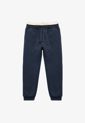 Navyblauwe sweatpants van een textuurstof, met een elastische tailleband, verstelbaar trekkoord en taps toelopende boorden. Inclusief zijzakken.