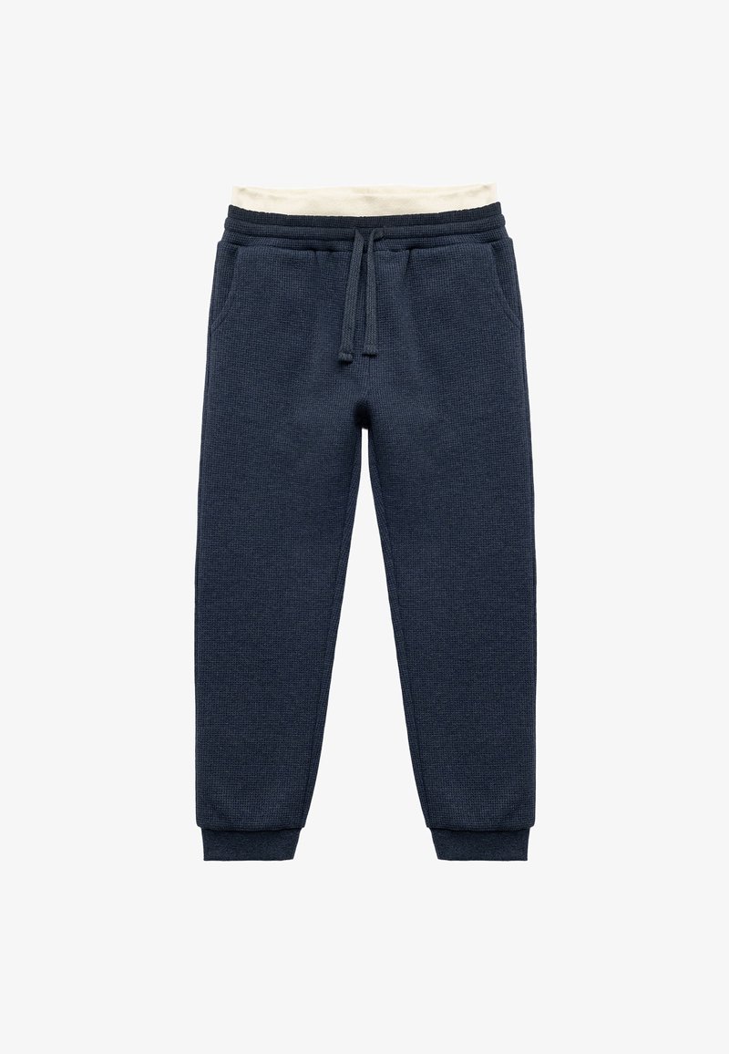 Marineblaue Jogginghosen aus einem strukturierten Stoff, mit elastischem Bund, verstellbarem Kordelzug und schmal zulaufenden Bündchen. Seitentaschen vorhanden.