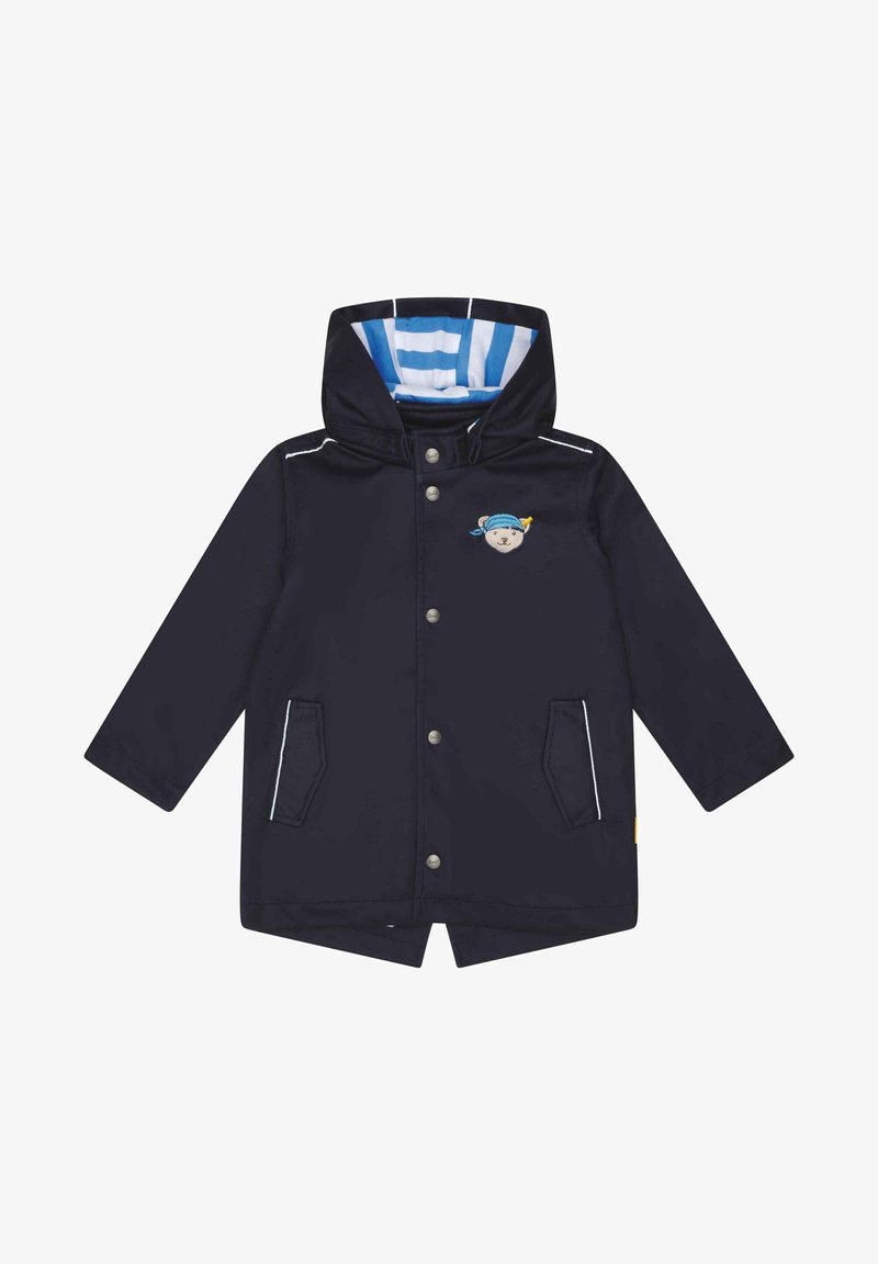 Imperméable enfant bleu marine avec capuche doublée de rayures bleues et blanches, boutons-pression, deux poches avant et une petite broderie d'ourson sur la poitrine.