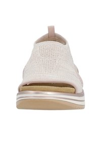 Open-toe sandal in light pink knit fabric with a textured design, cushioned insole, and a rubber sole featuring a decorative accent.