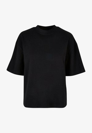 Črna bombažna majica z visokim ovratnikom, kratkimi rokavi in ohlapnim, kvadratnim krojem brez vidnih vzorcev ali poudarkov.