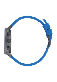 Stilīgais pulkstenis ar apaļu pelēku korpusu, zilu silikona siksniņu, diviem sānu pogām un teksturētu kroni laika regulēšanai.