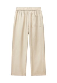 Beige Baumwollhosen mit elastischem Bund, weitem Bein und einer einzelnen Gesäßtasche. Weiche Textur ohne sichtbare Muster oder Beschläge.