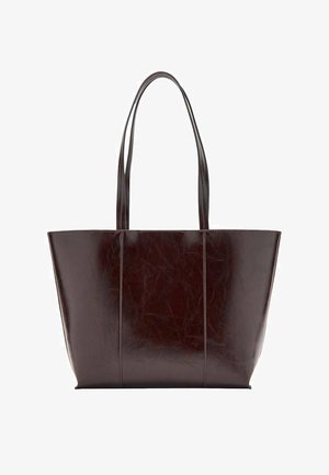 Dark brown leather tote bag with smooth texture, structured shape, two long handles, and vertical seam detailing on the front.