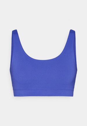 Fialová podprsenka s hladkým, elastickým materiálom. Má široké ramienka a zaoblený výstrih. Minimalistický dizajn bez ozdôb.