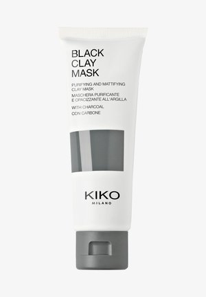 Purifying black clay mask in a white tube with gray accents. Features brand name and product details in black text. Squeeze dispenser at bottom.