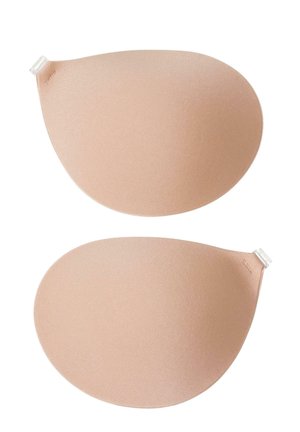 Coussinets en silicone de couleur pêche douce, de forme ovale avec une texture lisse, dotés d'un adhésif transparent en haut pour une application sécurisée.
