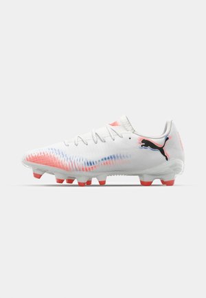 White football boots with a textured upper featuring a gradient of pink and blue accents. Includes orange studs and a black logo on the side.
