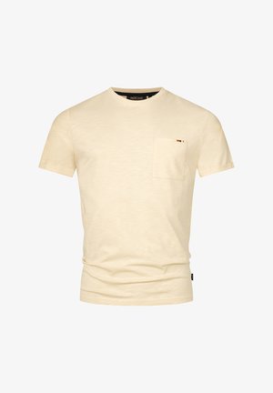 Vaaleanbeige T-paita, joka on valmistettu pehmeästä kankaasta ja jossa on pyöreä kaula-aukko, lyhyet hihat sekä yksi rintatasku, jossa on pieni värillinen korostus.