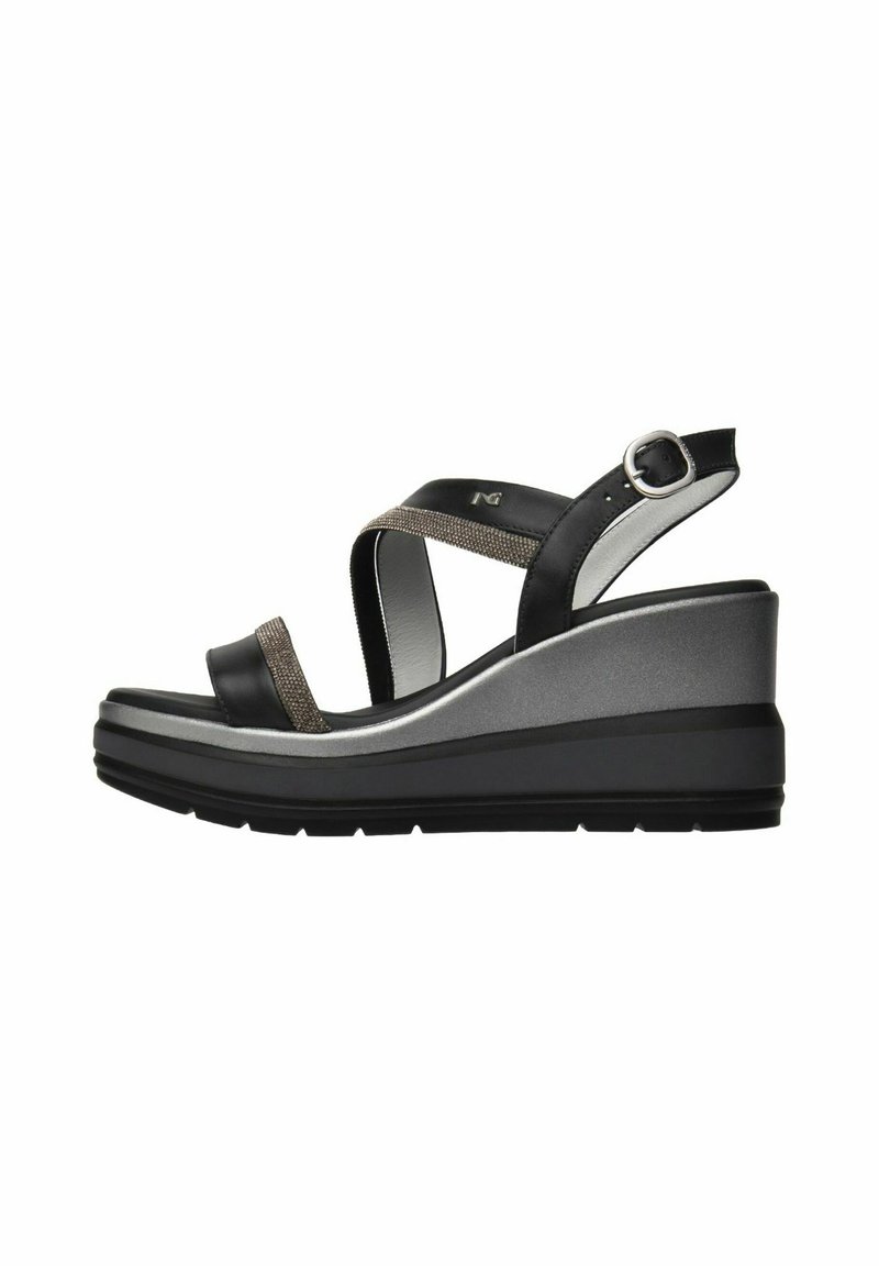 Black and silver wedge sandals feature a textured strap and ankle buckle, with a contoured platform and rubber sole for stability.