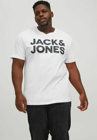 White short-sleeve t-shirt featuring large black text, "JACK & JONES," with a crew neck. Fabric appears smooth, and the fit is relaxed.