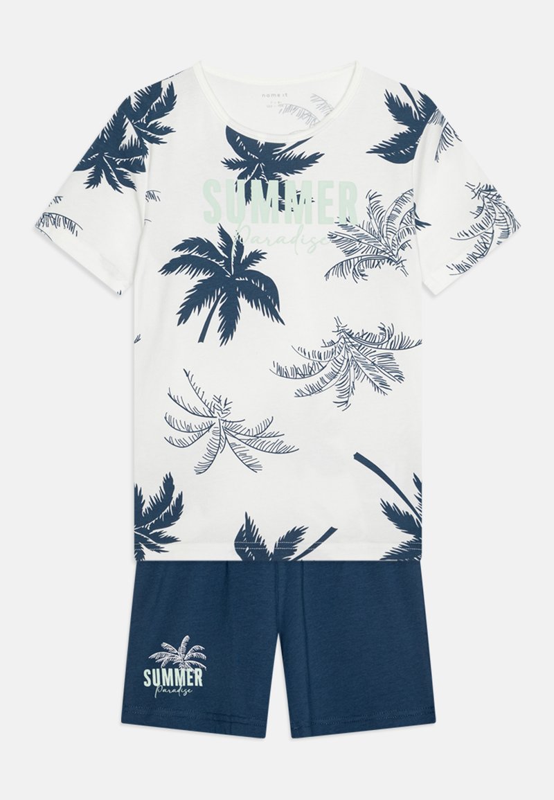 Biele pyžamo s krátkymi rukávmi a námorníckym potlačou paliem, so slovami "SUMMER Paradise". Námornícke šortky dopĺňajú outfit. Mäkký bavlnený materiál.