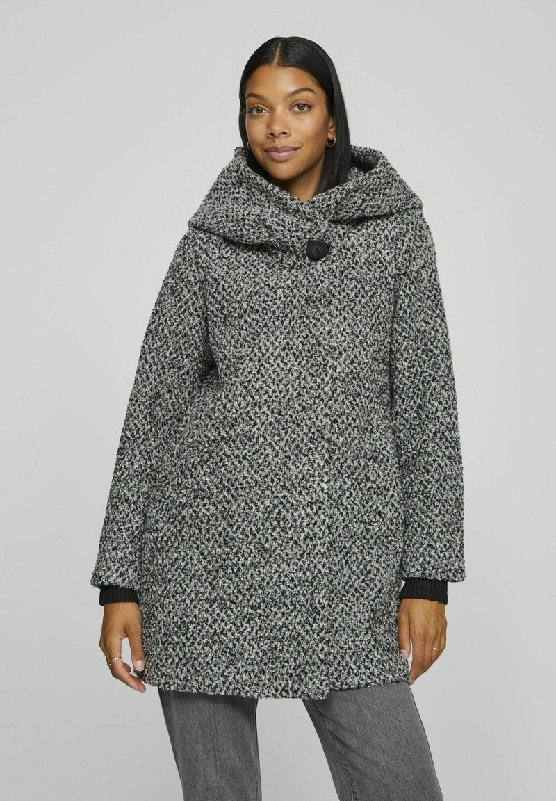 Gray and black patterned coat with a large hood and a button closure. Features loose-fit sleeves with ribbed cuffs and a textured fabric.