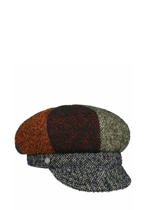 Patchwork flat cap with textured wool in orange, black, red, olive, and navy colors, featuring a short brim and a small metal side emblem.