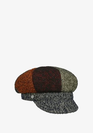 Patchwork flat cap with textured wool in orange, black, red, olive, and navy colors, featuring a short brim and a small metal side emblem.