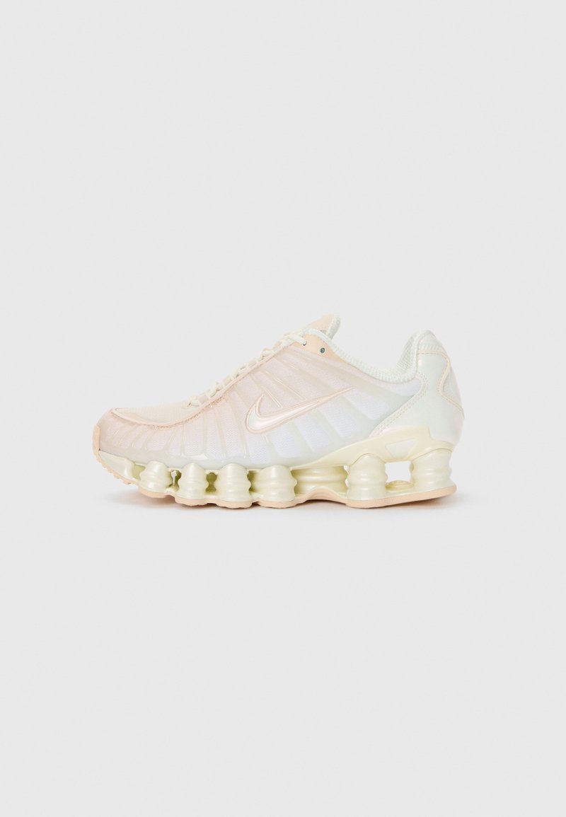 Nike shoes featuring a translucent upper in soft pastel shades, textured panels, and a distinctive cushioned sole composed of stacked segments.