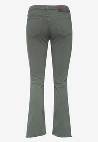 Pantalones vaqueros acampanados verdes en mezcla de algodón con un dobladillo deshilachado, que cuentan con dos bolsillos traseros y una etiqueta marrón en la cintura.