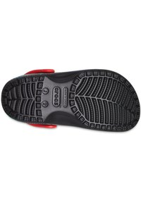 Sohle eines schwarzen Crocs-Schuhs mit strukturiertem Profil und sichtbarem roten Riemen, Größe J2, hergestellt in China.