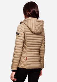 Bežna prešita puffer jakna s kapuco, ki vsebuje horizontalne in rombaste vzorce, črne detajle ter rdečo oznako ob robu.