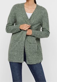 Light green knitted cardigan with a v-neck, open front, long sleeves, and side pockets, made from soft textured material.