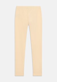 Beige leggings made of soft knit fabric, featuring a stretchy waistline and a smooth texture. No visible seams or patterns.