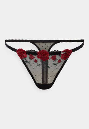 Zwarte doorschijnende thong met geborduurde rode rozen en groene bladeren, voorzien van een polka dot gaaspatroon en golvende randen.